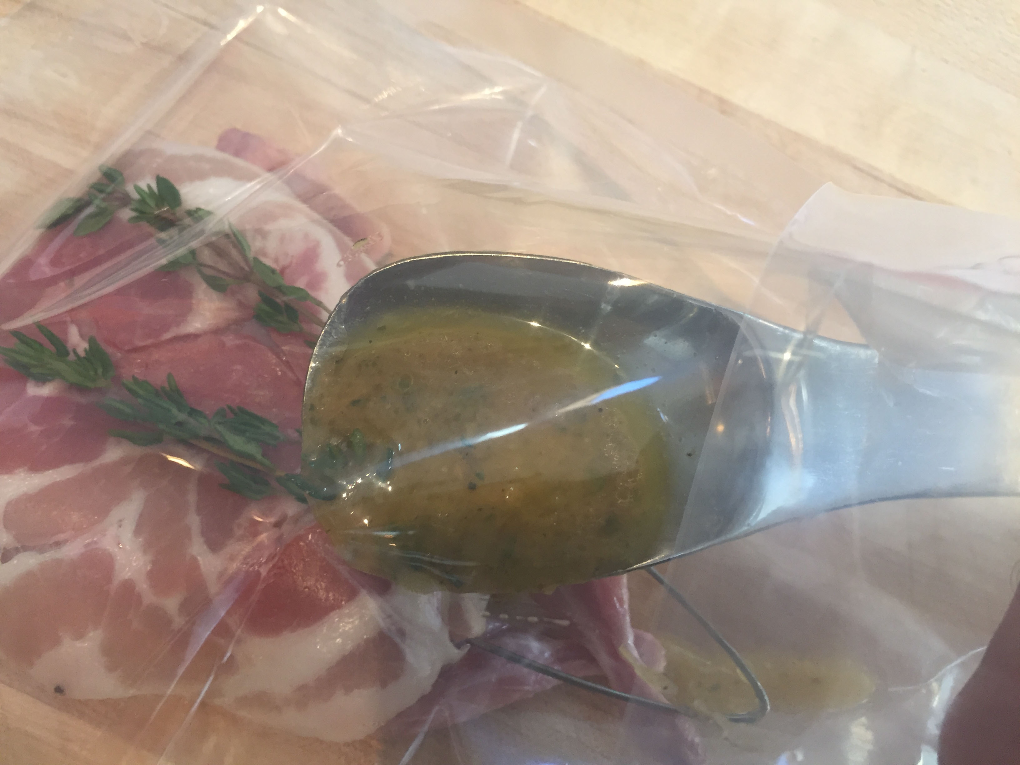 adding marinade to meat in vacuum bag