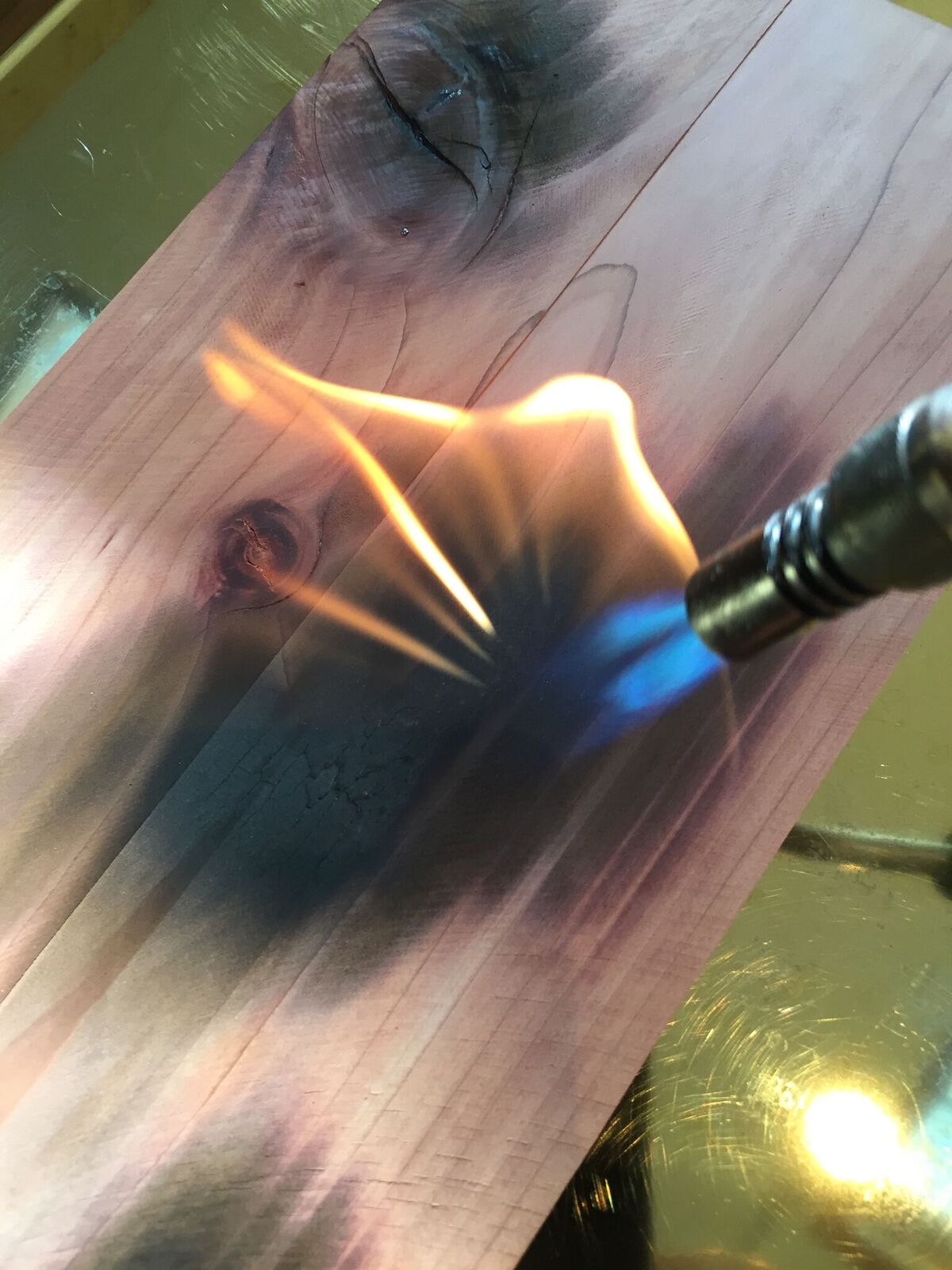 blow torching cedar plank