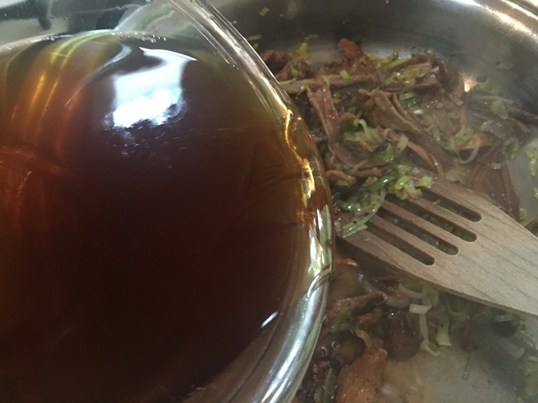 Adding mushroom water to sautee pan